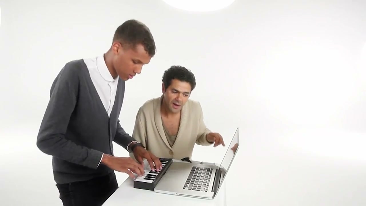 The original keyboard player and partner performing beside the laptop before dancing together in the white studio