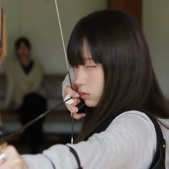An archery-themed character montage moves between bow handling, indoor portraits, a car window and garden scenes