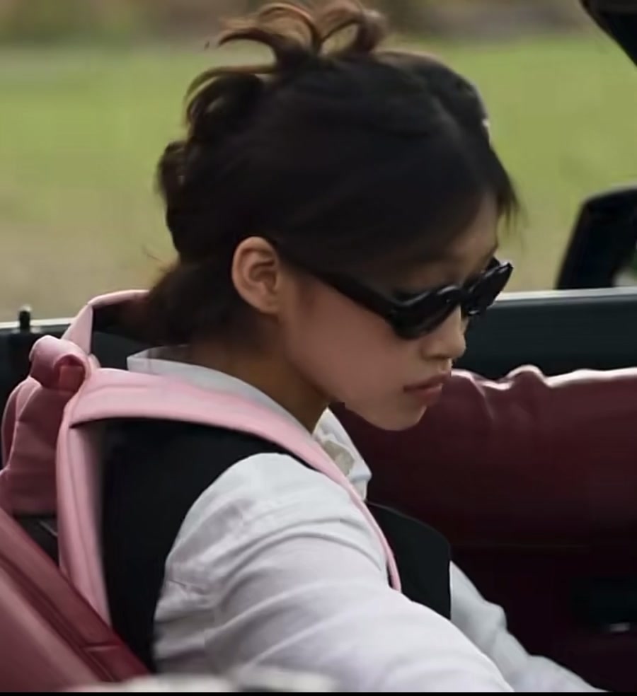 The same lead in the car shot wearing sunglasses
