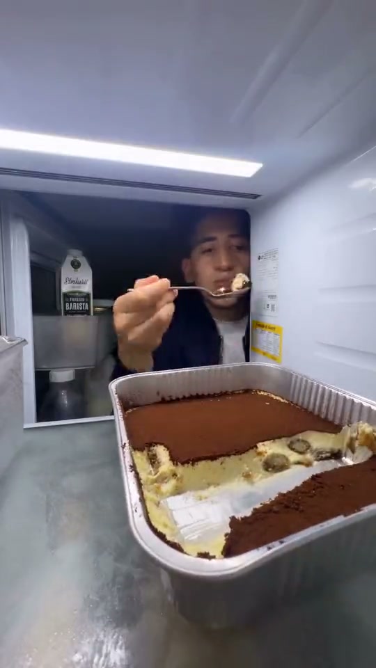 Original fridge reference: a person takes spoonfuls of tiramisu, closes the door and returns for another bite