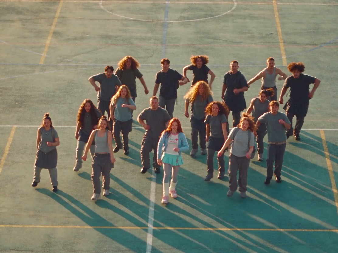 The playground crowd returns around the front-center lead after the trio