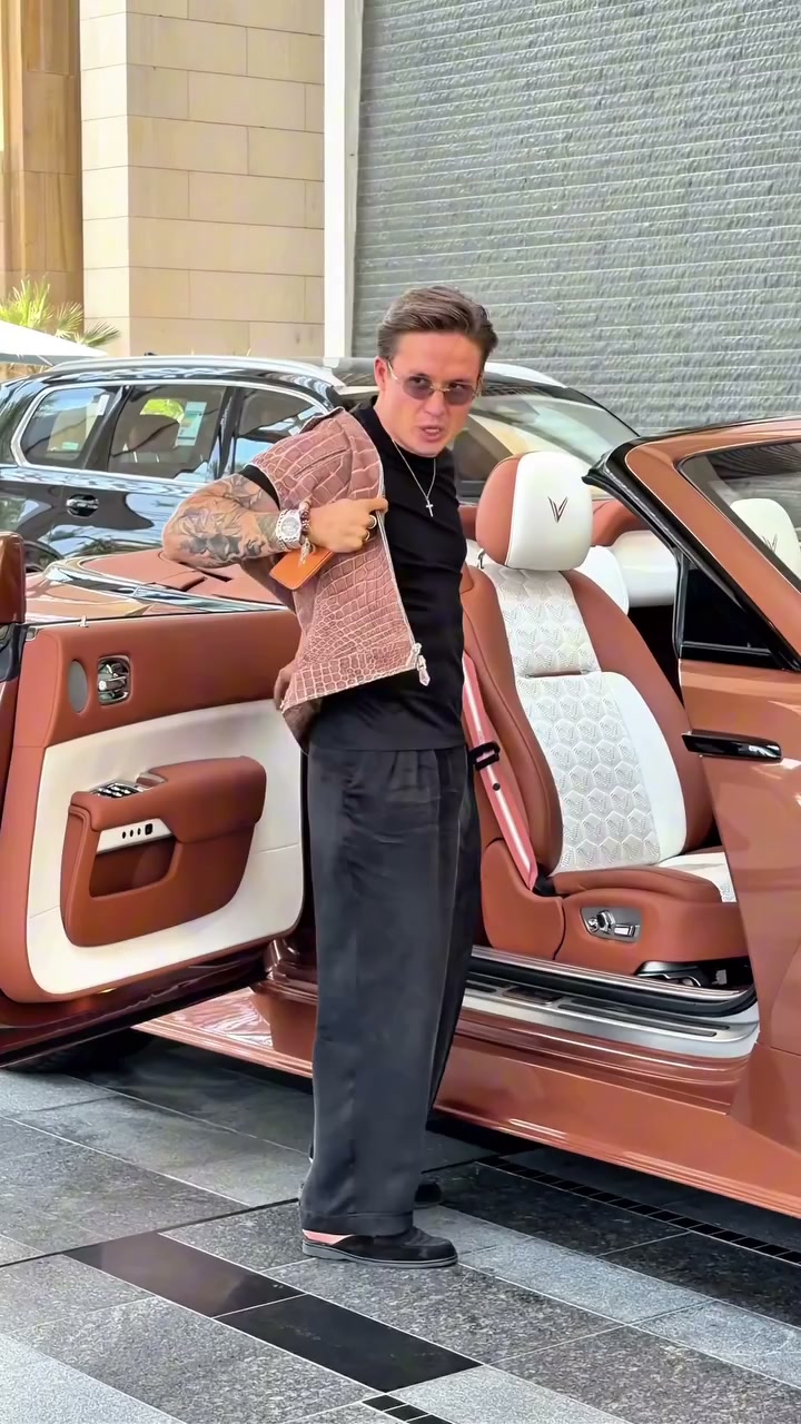 Character beside a rose-gold convertible