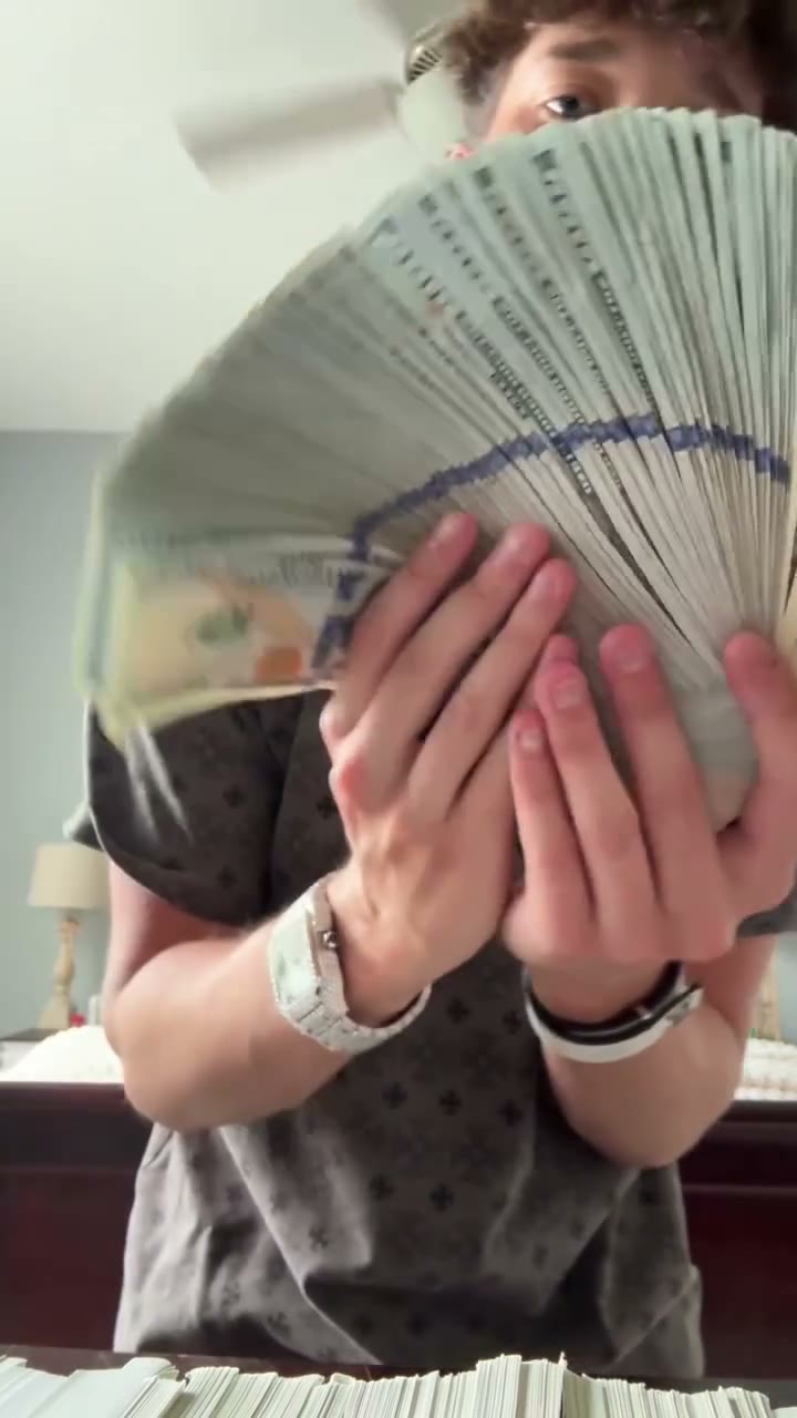 Money fan partly covering the source performer’s lower face near the end